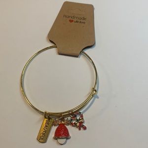 Handmade gold tone stainless steel bracelet with 3 charms.